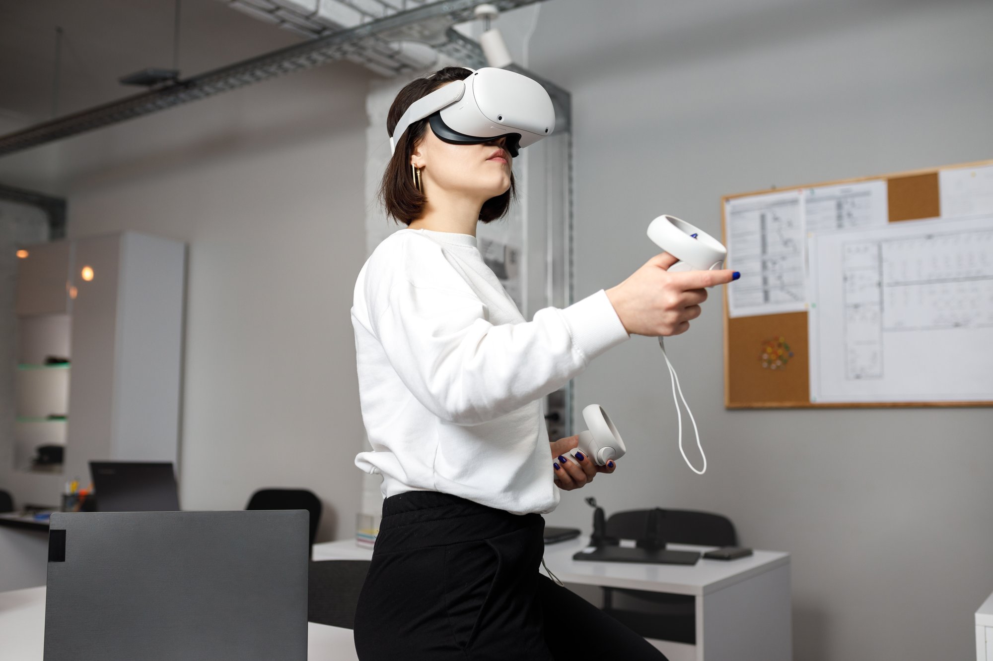 team-four-creative-engineers-working-with-virtual-reality-young-woman-testing-vr-glasses-goggles-sitting-office-room