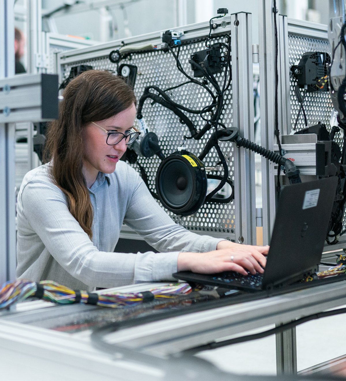 Woman working at a computer, coding a new software program