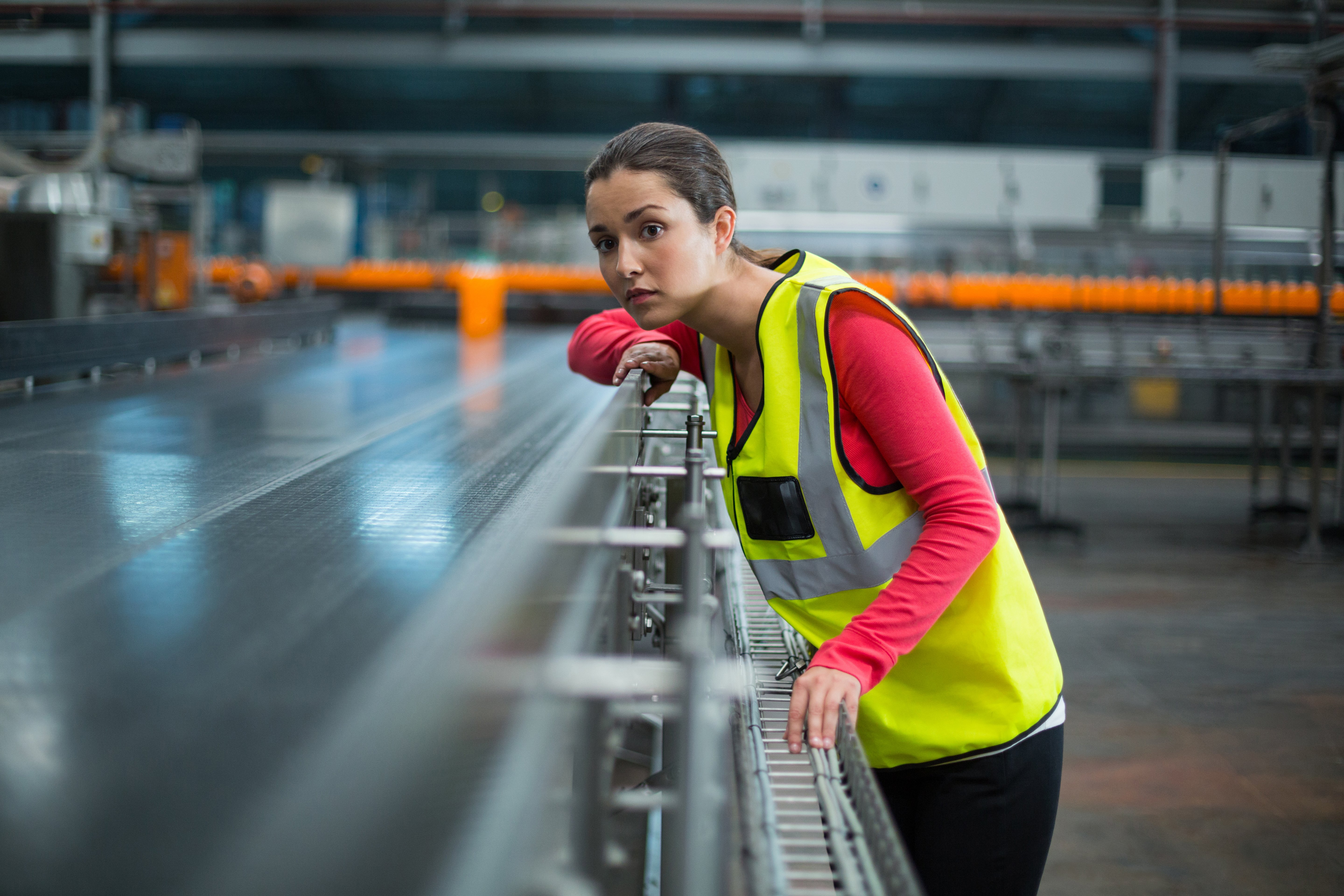 Young woman looking at conveyor belt