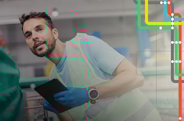 Man holding a tablet observes products in a warehouse