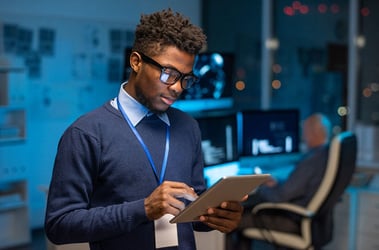 Young programmer scrolling touchpad while looking through new computer software