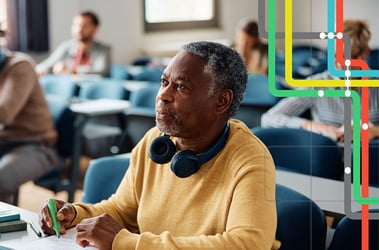 Man sitting at a table taking notes