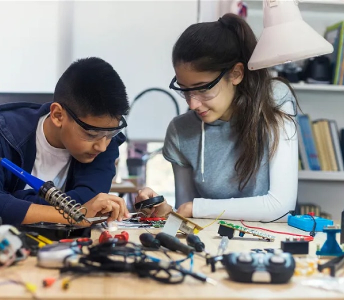 Woman and boy working on electronics together