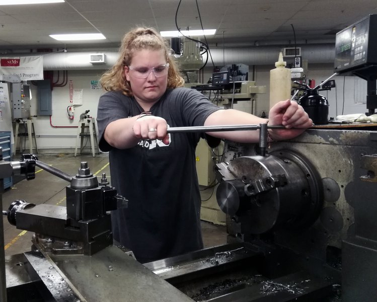 Person working on machinery in a work environment