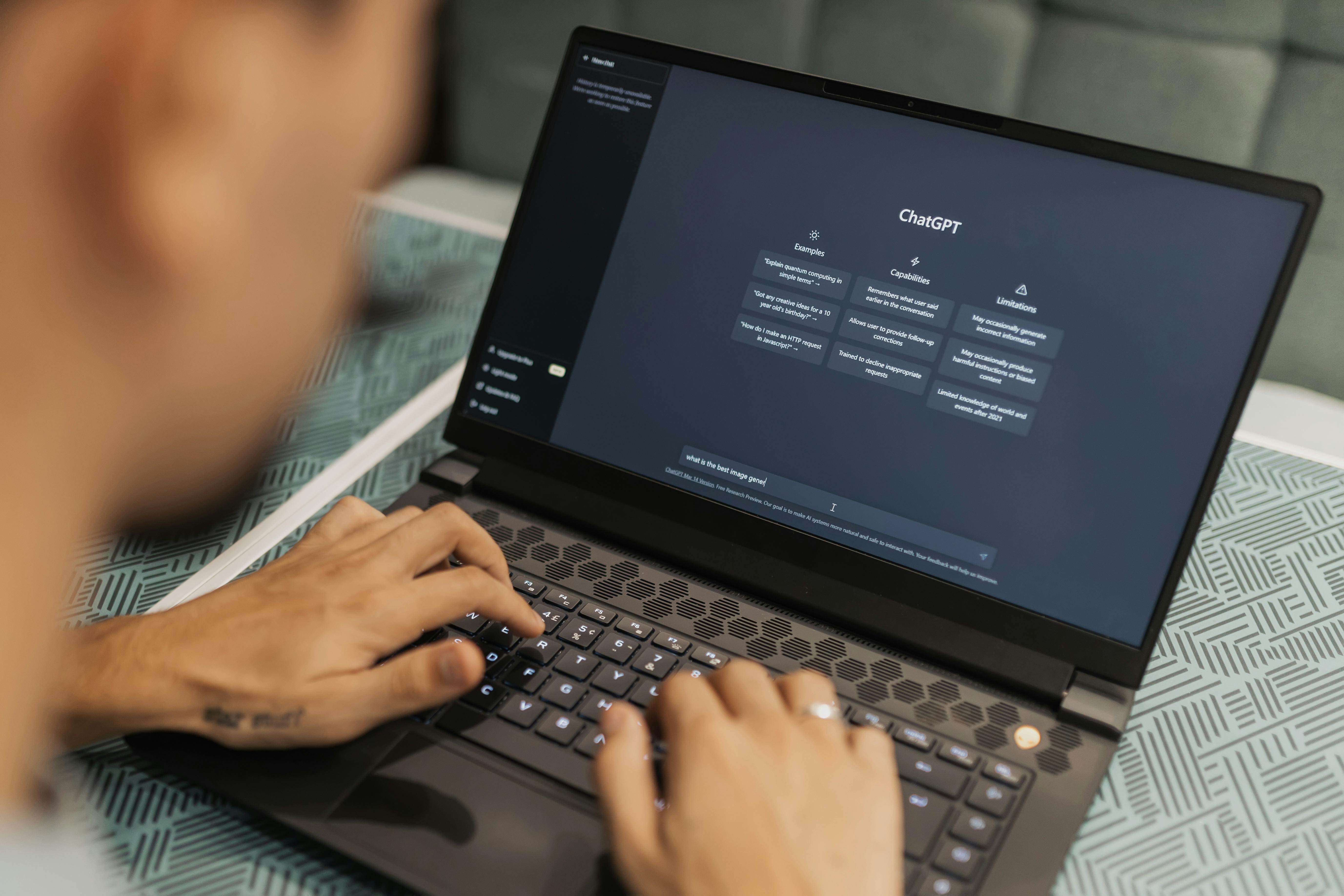 Image of hands on a computer using ChatGPT
