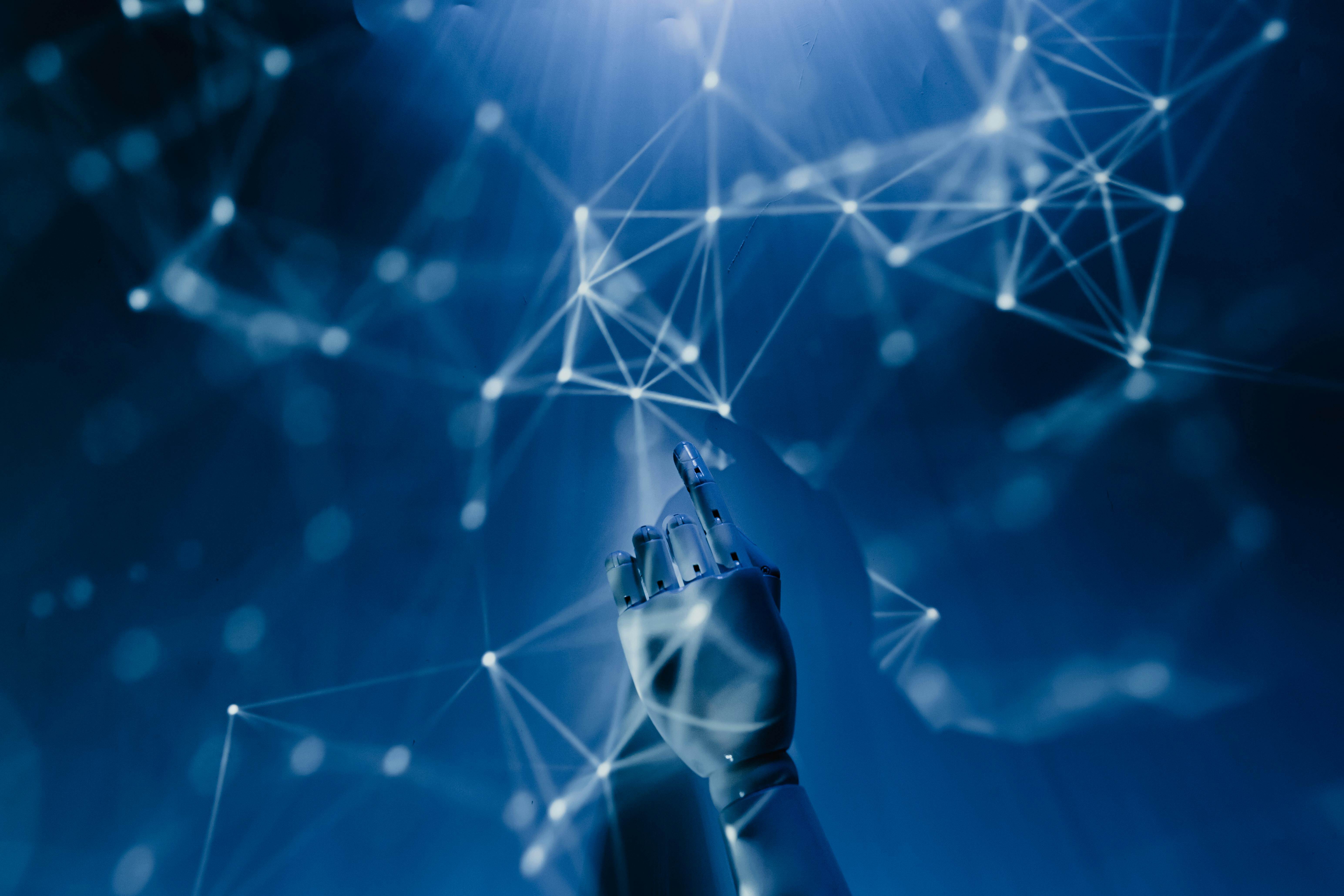 Image of blue hands pointing to a network of lines