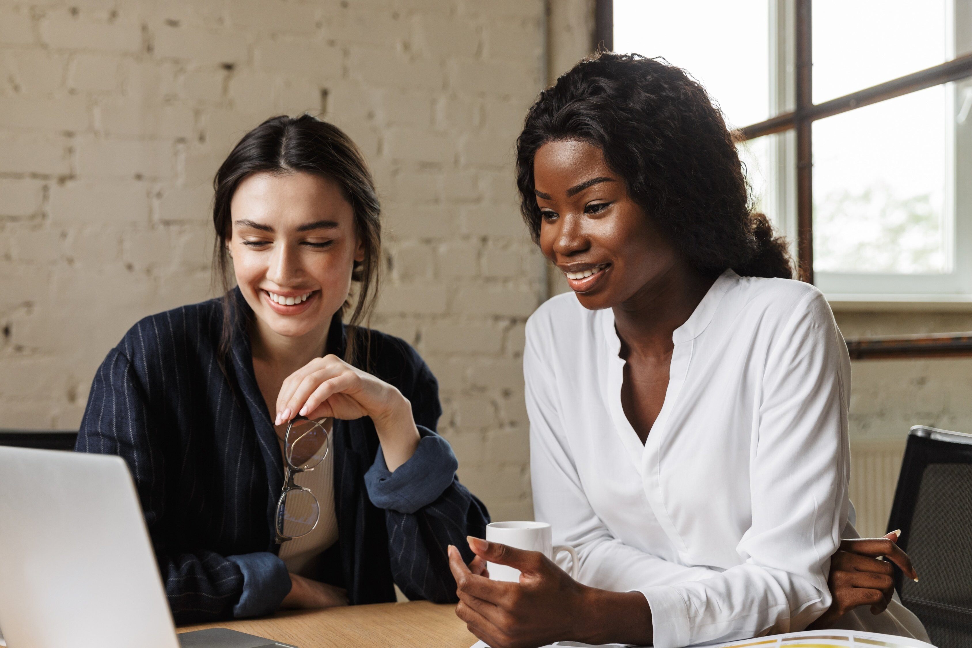 Image of two people working collaboratively.