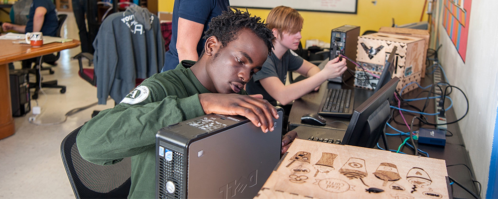 Photo of a training program participant working on computer repairs.